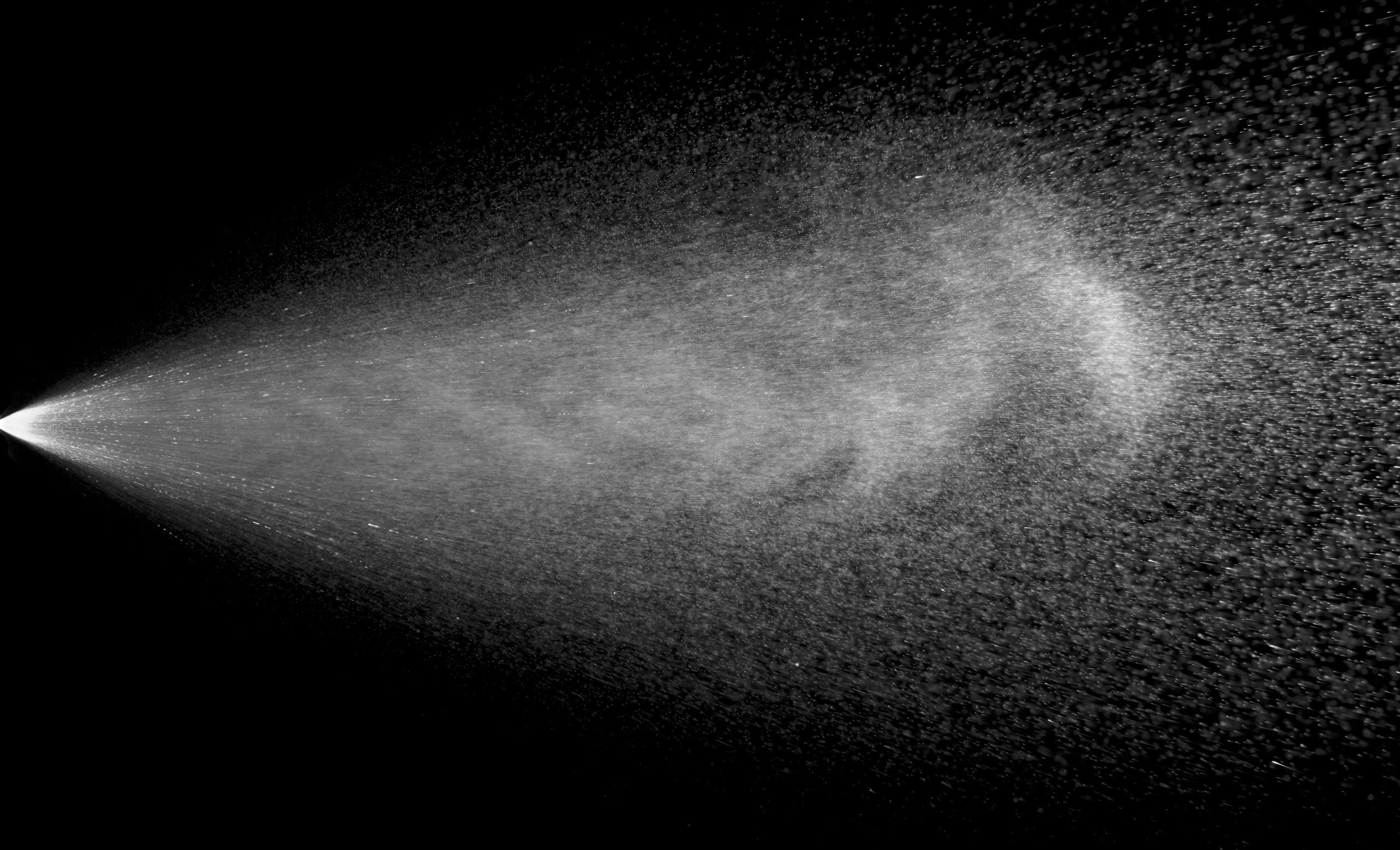 a stream of spray on a black background