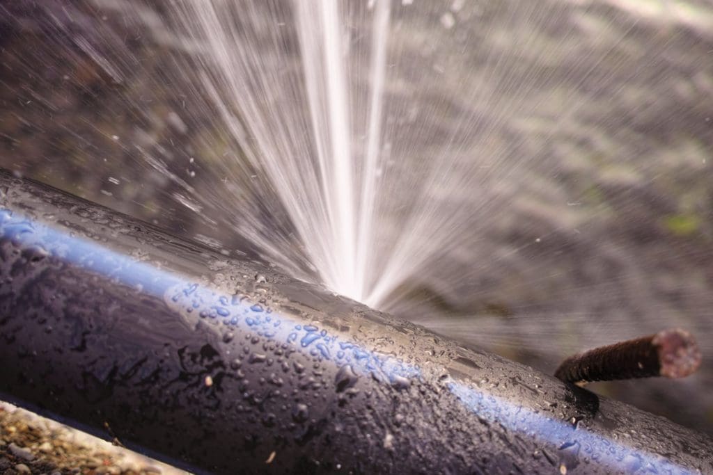 water spraying out of a pipe burst
