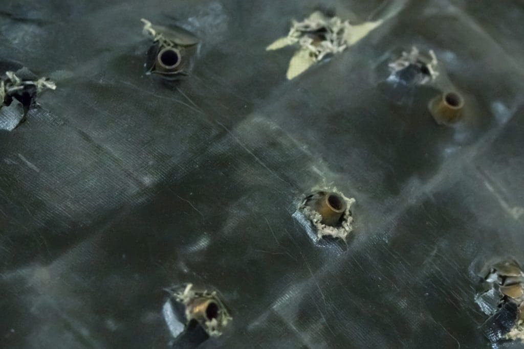 steel armor sheet with puncture marks from bullets